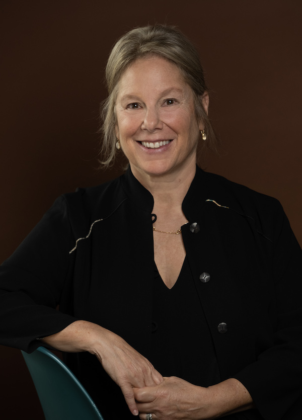 Jill Medvedow, a smiling, fair-skinned middle-aged woman with blond hair pulled back and a black jacket.